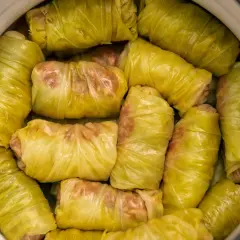 Gołąbki w garnku, gotowe do podania. Zastanawiasz się, co podać do gołąbków? Sos pomidorowy lub śmietanowy to klasyka!