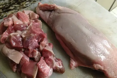 Pokrojone mięso wieprzowe i surowy ozór wieprzowy, gotowe do przygotowania. Dowiedz się, jak zdjąć skórę z ozorków wieprzowych.