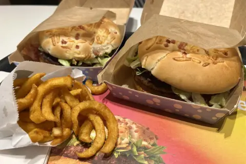 Dwa burgery i porcja zakręconych frytek. Zastanawiasz się, ile kosztują frytki zakręcone w maku? Smacznego!