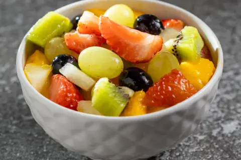 Kolorowa sałatka owocowa z truskawkami, kiwi, winogronami i mango. Idealna na lato, dowiedz się jak przygotować sałatkę owocową która nie ciemnieje przez kilka godzin.