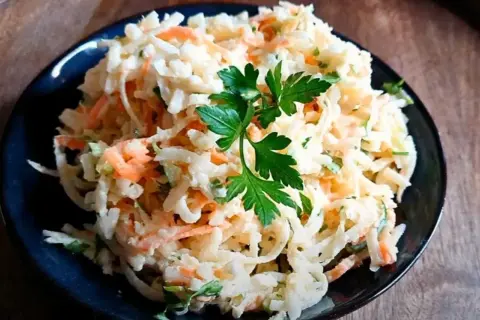 Pyszna surówka z tartej białej rzepy i marchewki, z natką pietruszki. Idealna, by dowiedzieć się, jak przygotować surówkę z białej rzepy bez charakterystycznej goryczki.