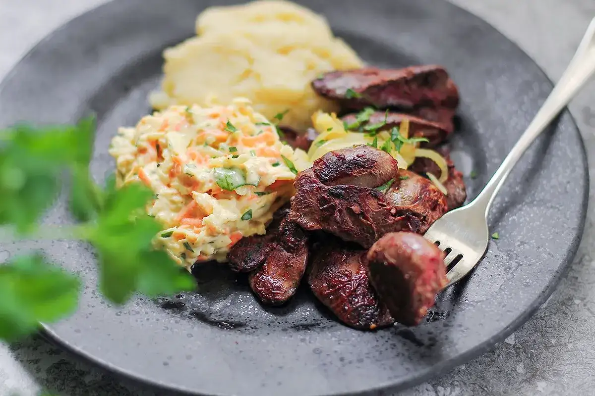 Smażona wątróbka z cebulką, puree ziemniaczane i surówka z marchewki i kapusty – idealne połączenie, które świetnie pasuje do wątróbki.
